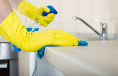 Cleaner working on upper-floor windows in SE3